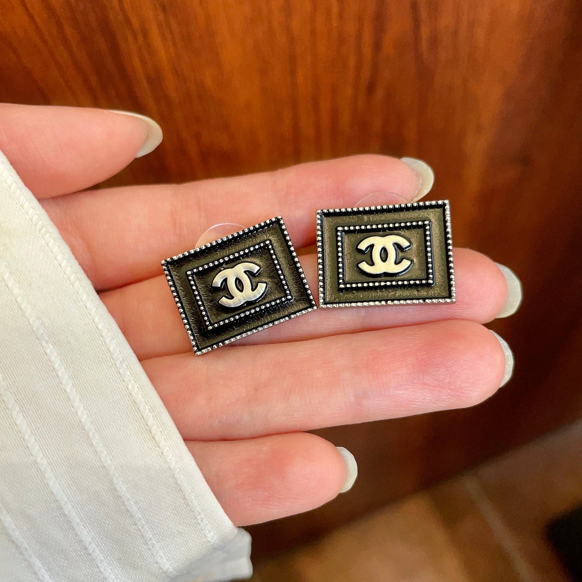 Martin Graham stud earrings in polished metal-tone – side detail