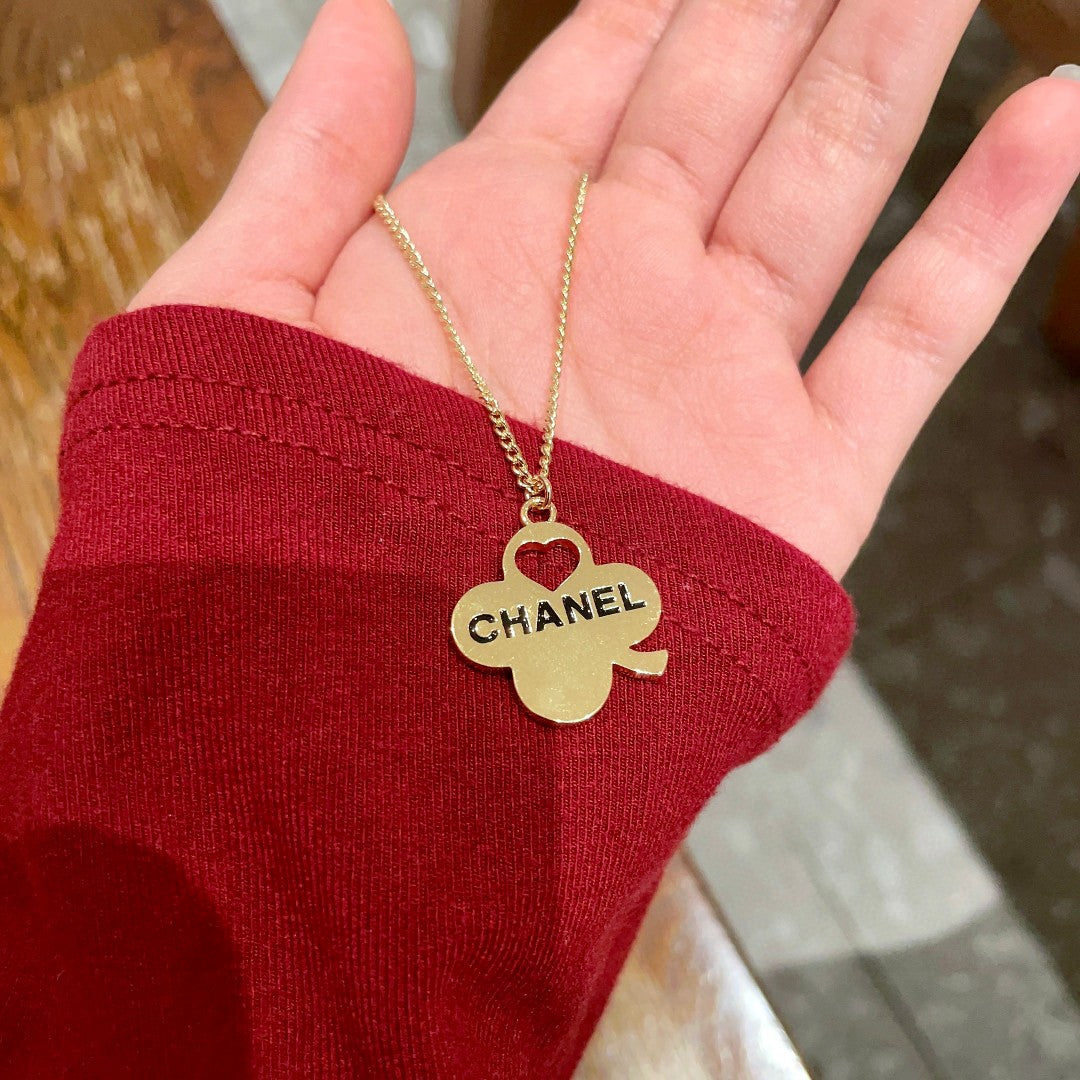 Martin Graham pendant necklace in polished metal-tone – side detail