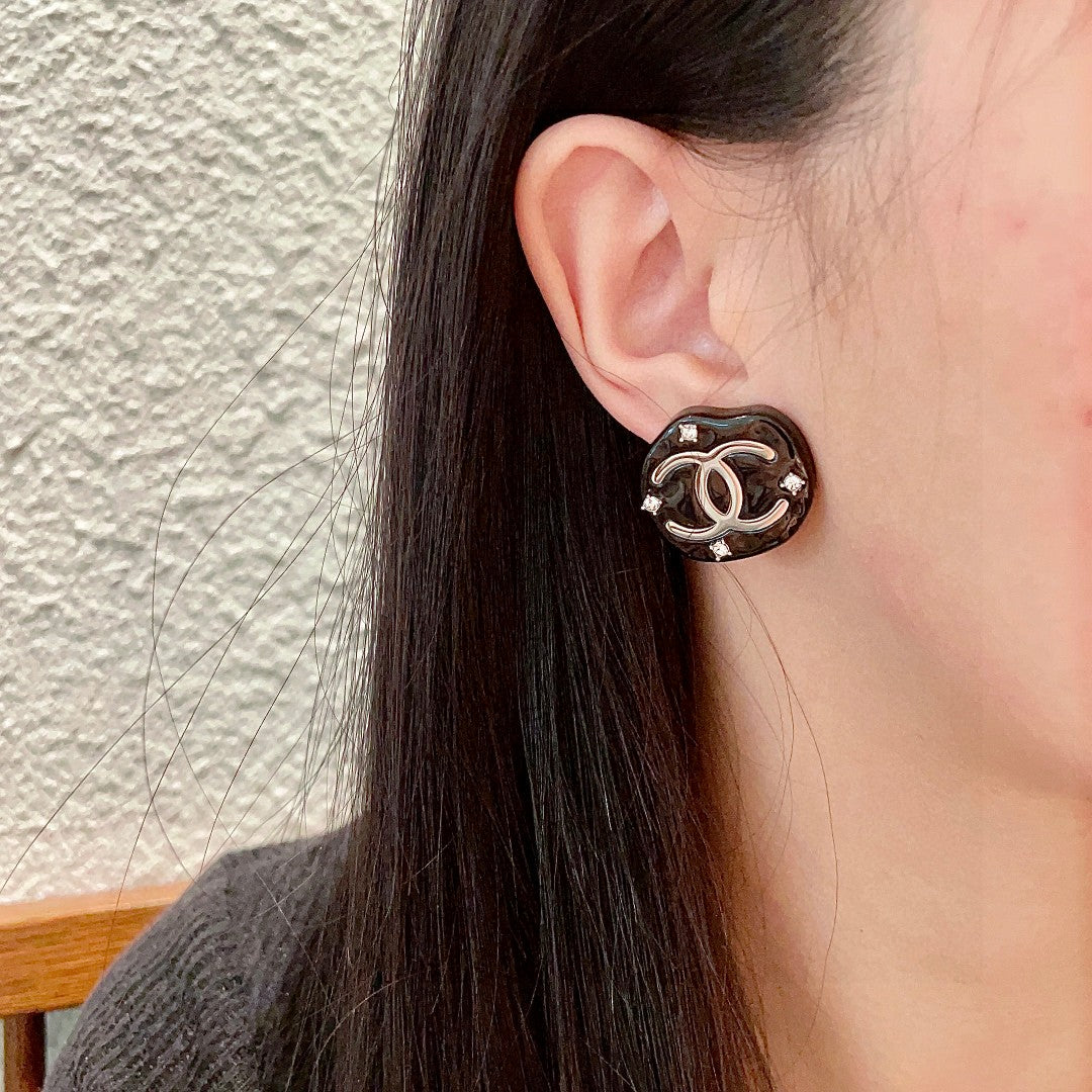 Martin Graham stud earrings in polished metal-tone – detail view