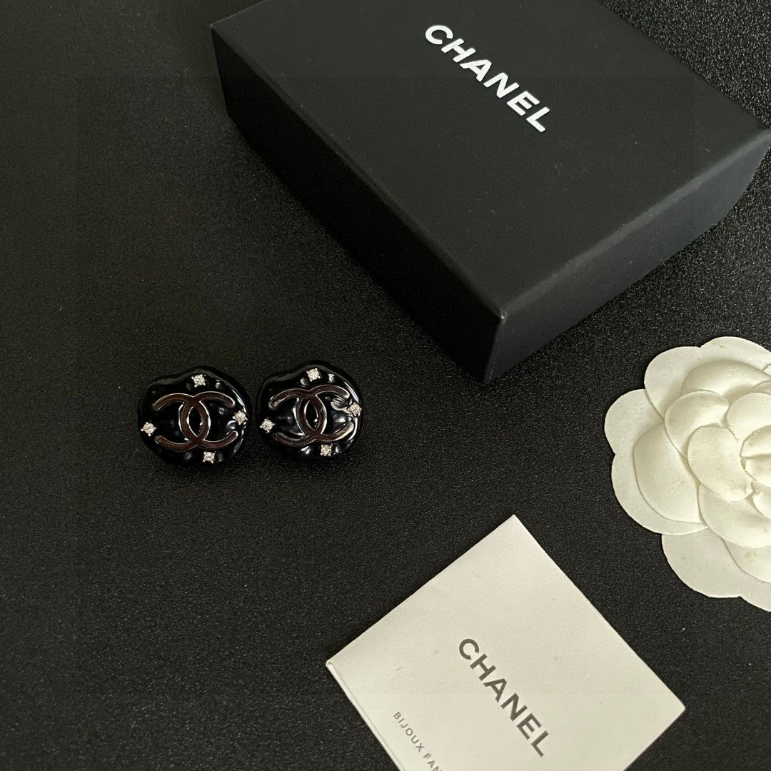 Martin Graham stud earrings in polished metal-tone – close-up detail