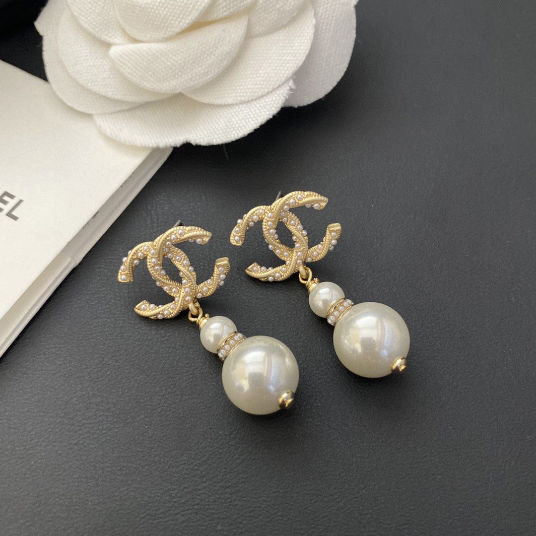 Martin Graham stud earrings in polished metal-tone – detail view