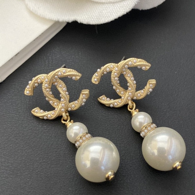 Martin Graham stud earrings in polished metal-tone – front product view