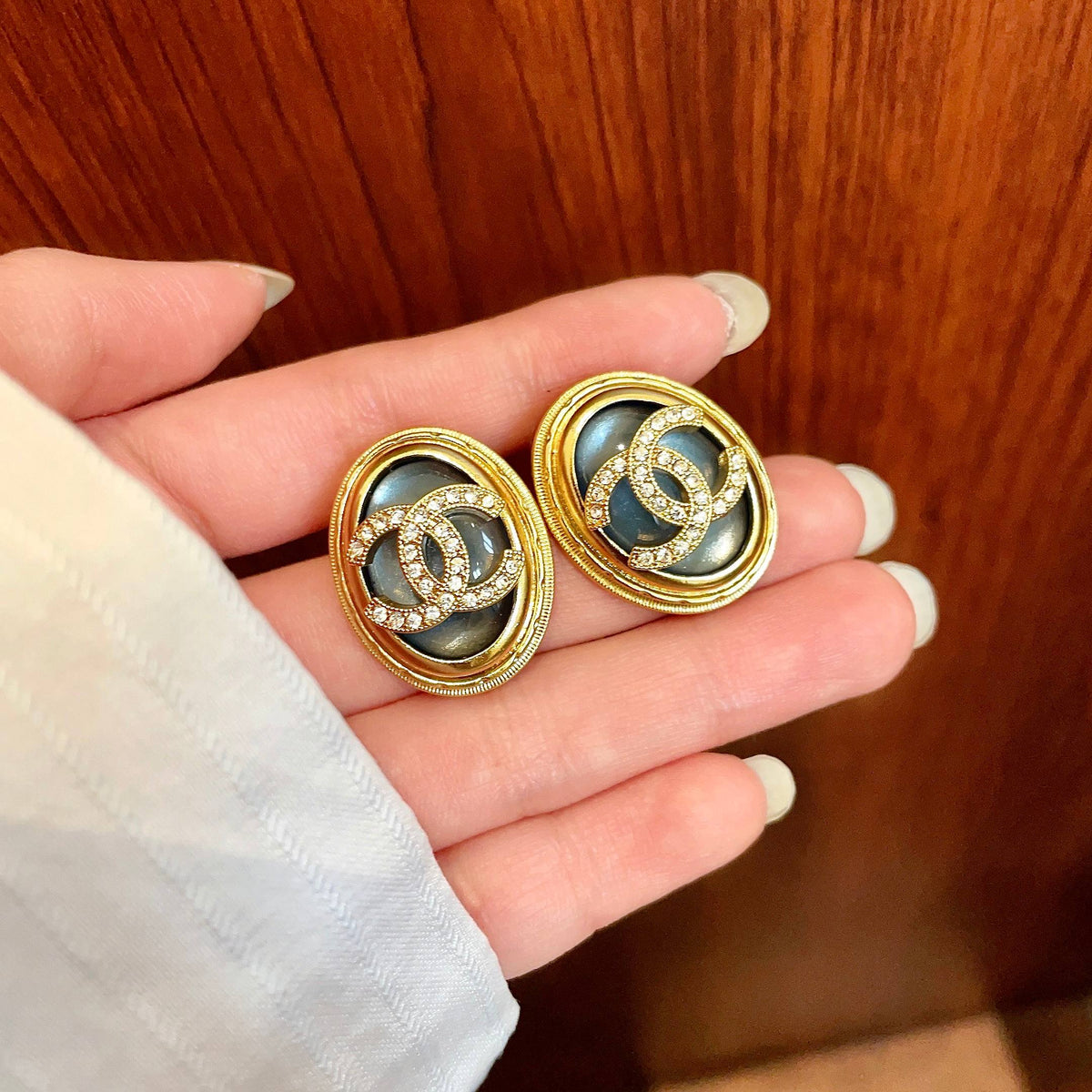 Martin Graham stud earrings in polished metal-tone – side detail