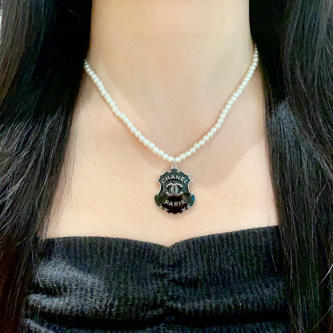 Martin Graham pendant necklace in polished metal-tone – detail view