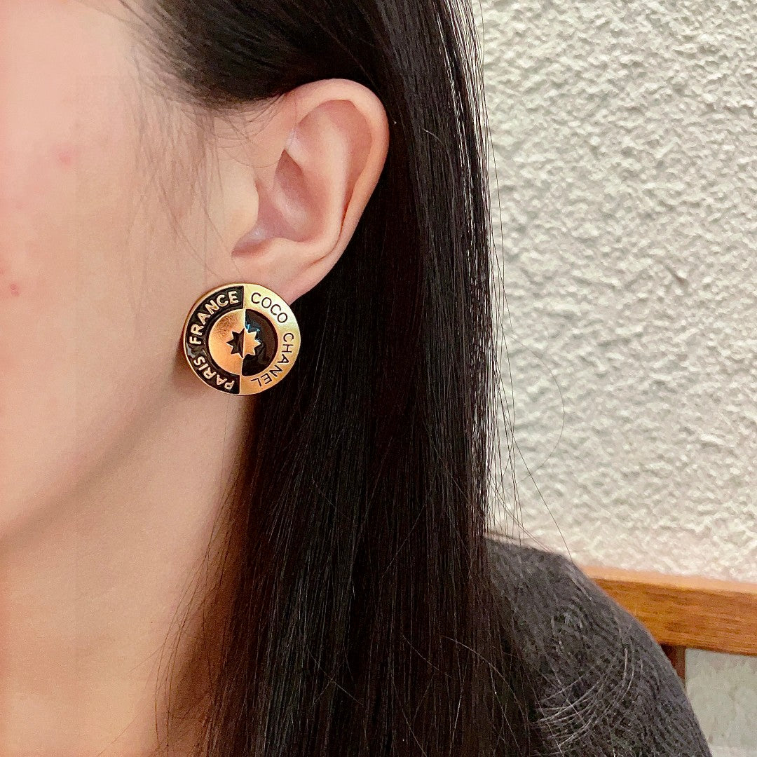 Martin Graham stud earrings in polished metal-tone – detail view