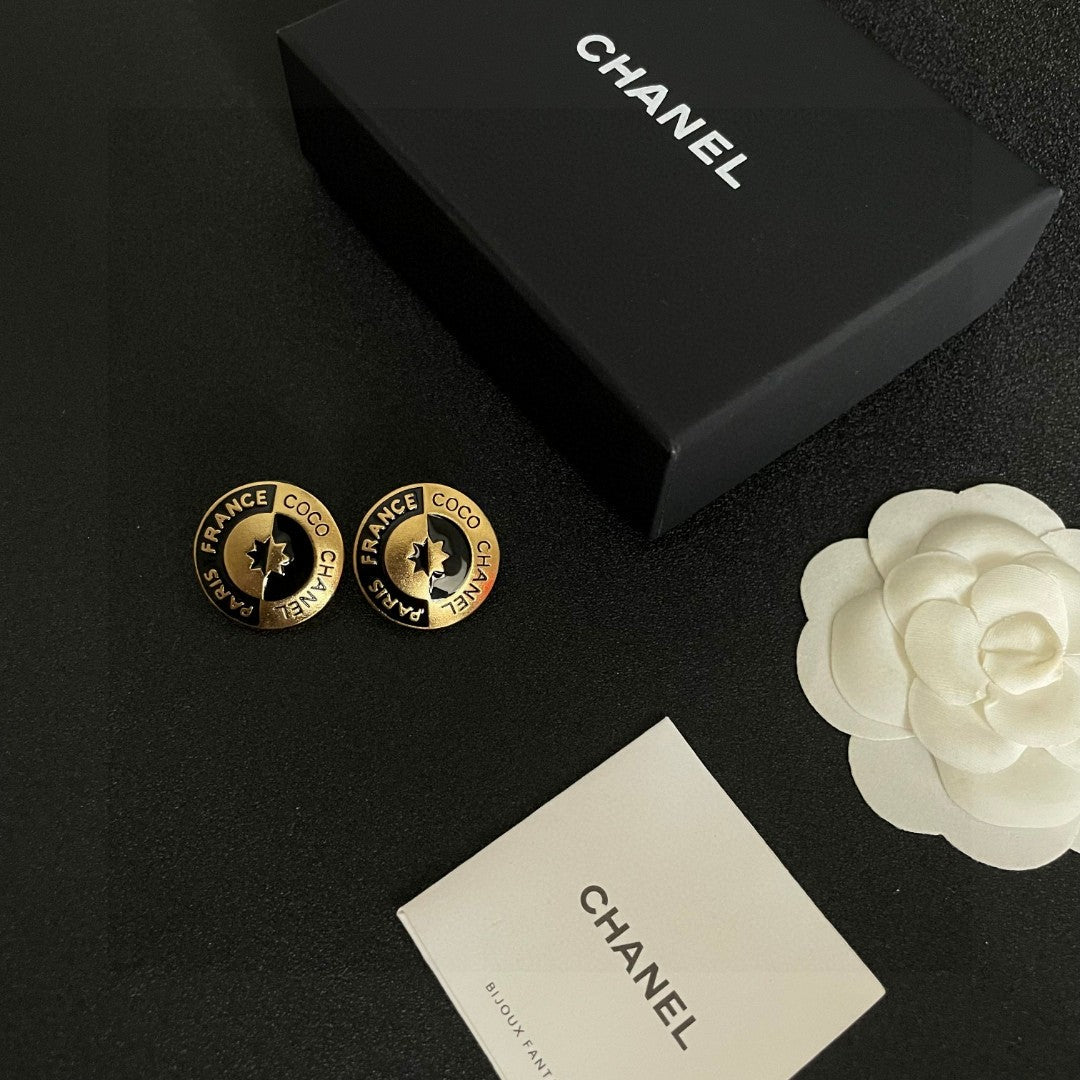 Martin Graham stud earrings in polished metal-tone – close-up detail