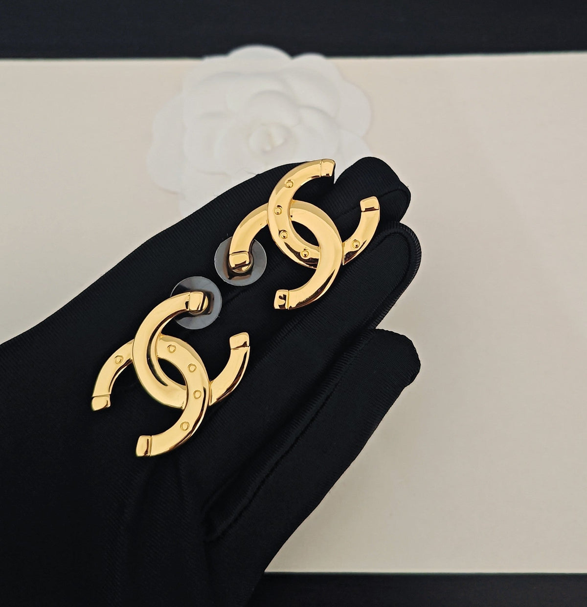 Martin Graham stud earrings in polished metal-tone – detail view