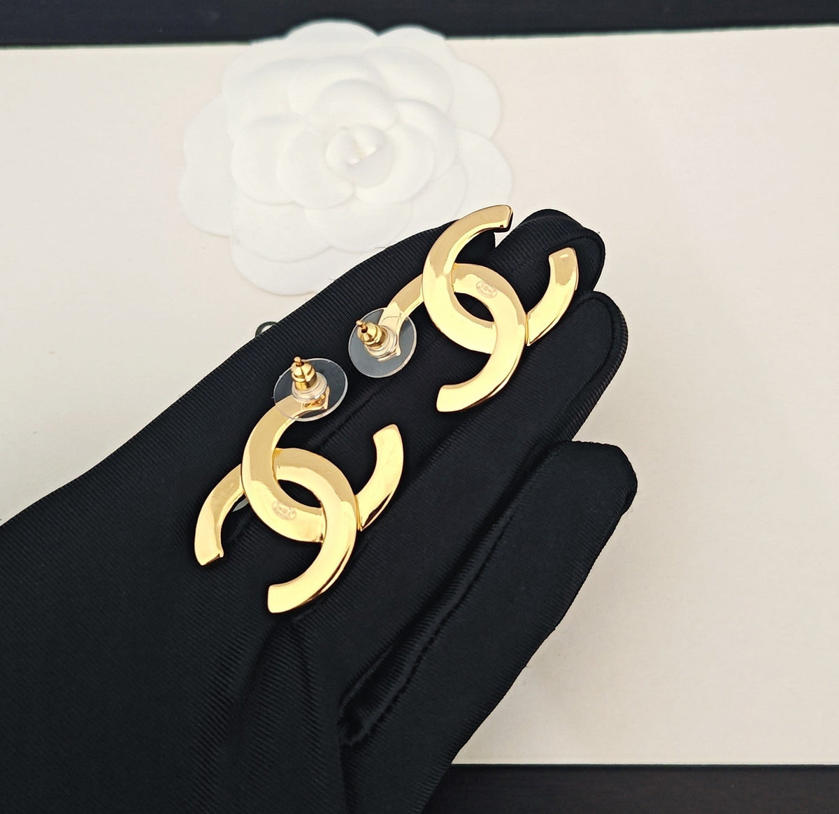 Martin Graham stud earrings in polished metal-tone – close-up detail