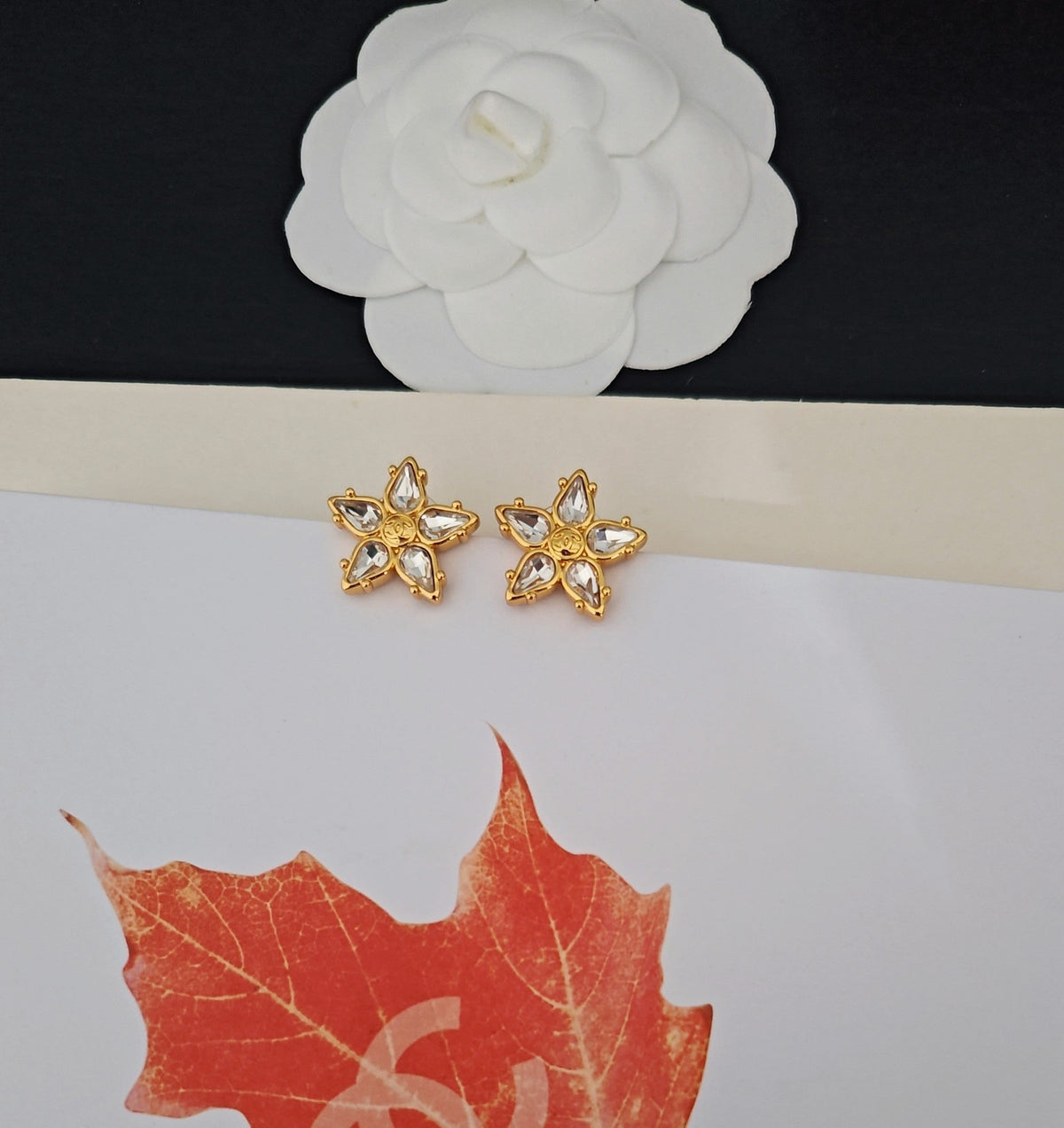 Martin Graham stud earrings in polished metal-tone – close-up detail