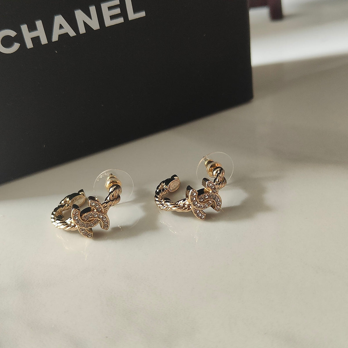 Martin Graham stud earrings in polished metal-tone – styled product view