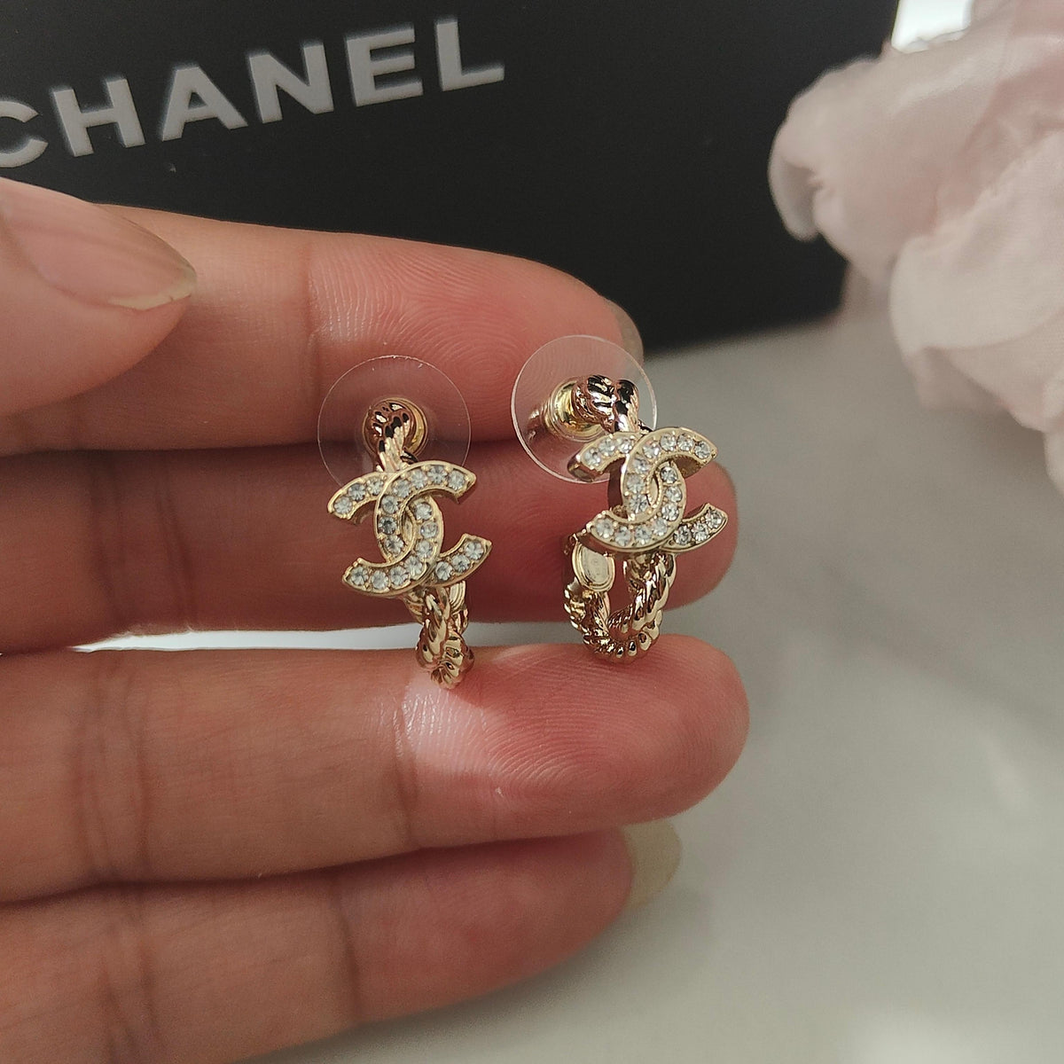 Martin Graham stud earrings in polished metal-tone – close-up detail