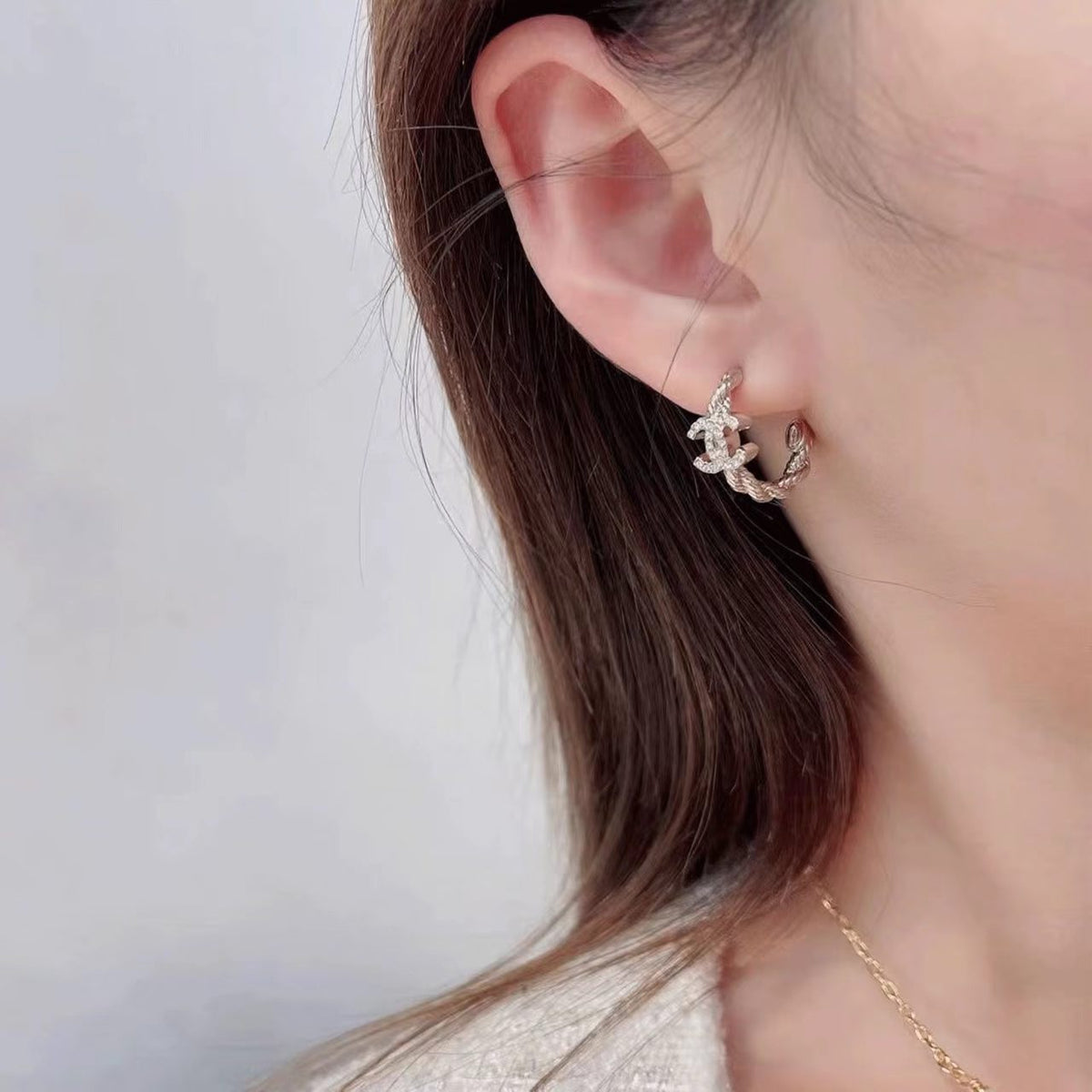 Martin Graham stud earrings in polished metal-tone – side detail
