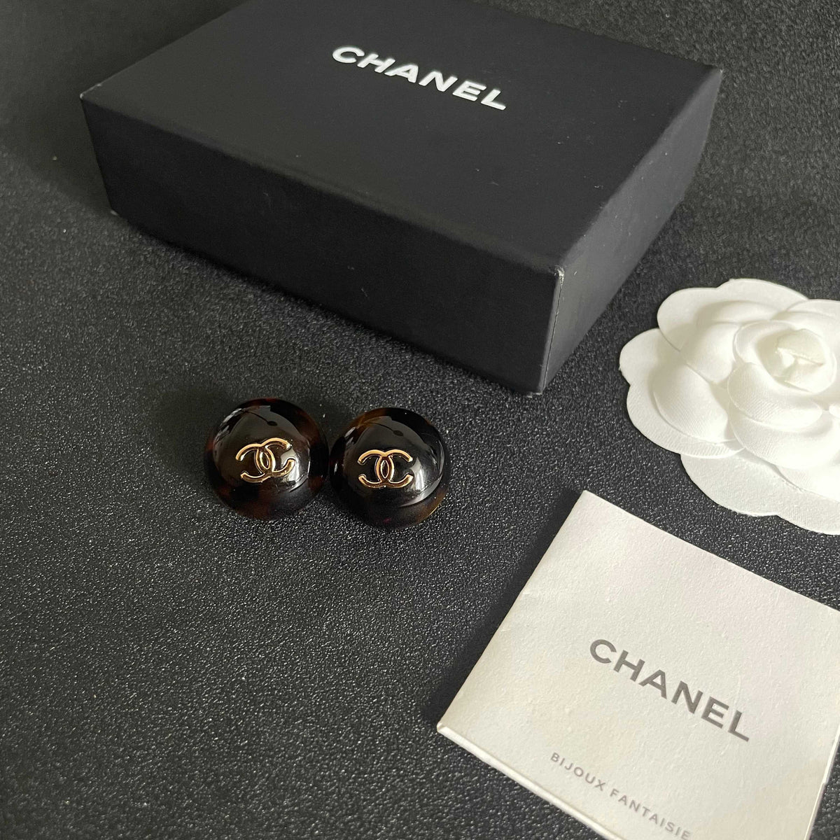 Martin Graham stud earrings in polished metal-tone – close-up detail