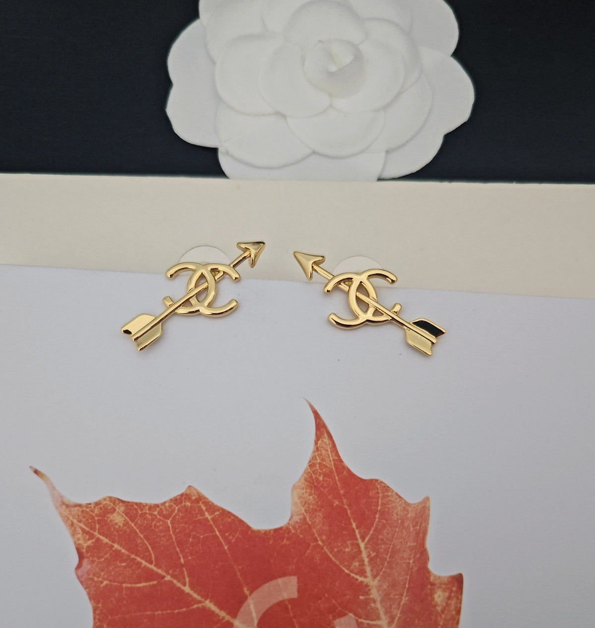 Martin Graham stud earrings in polished metal-tone – close-up detail