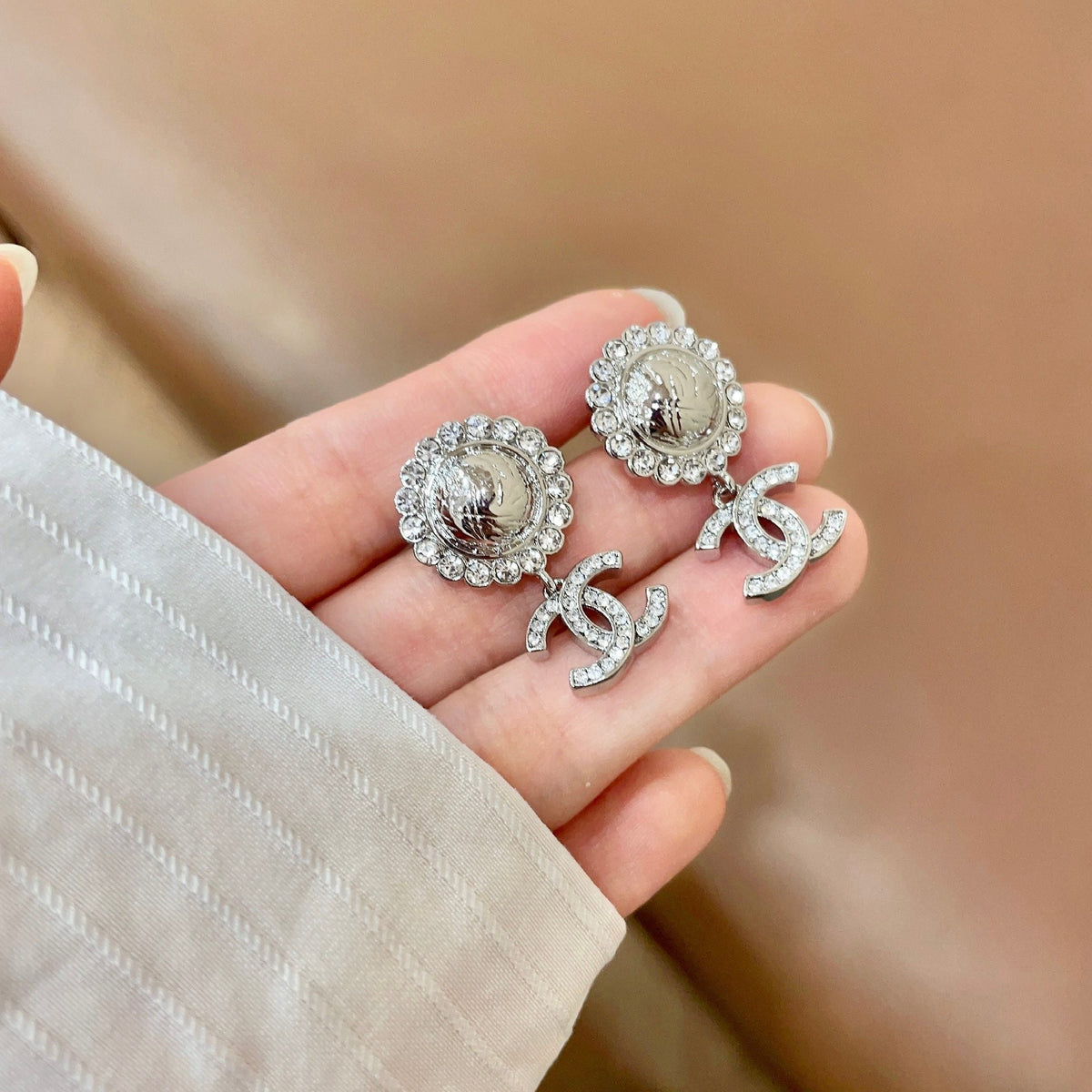 Martin Graham stud earrings in polished metal-tone – side detail