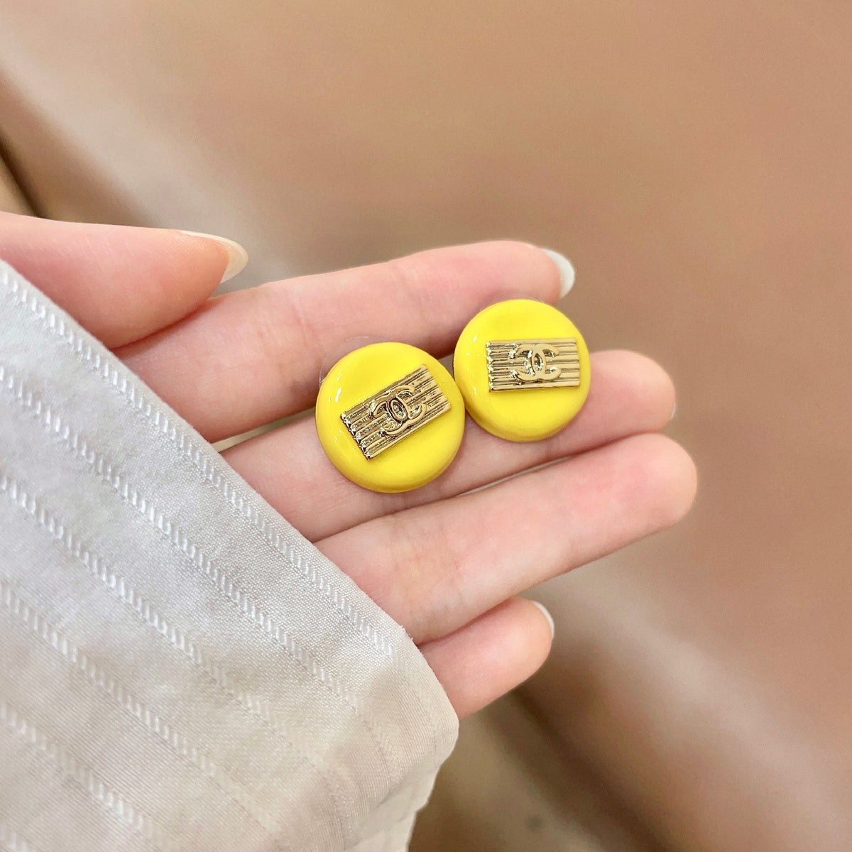 Martin Graham stud earrings in polished metal-tone – side detail