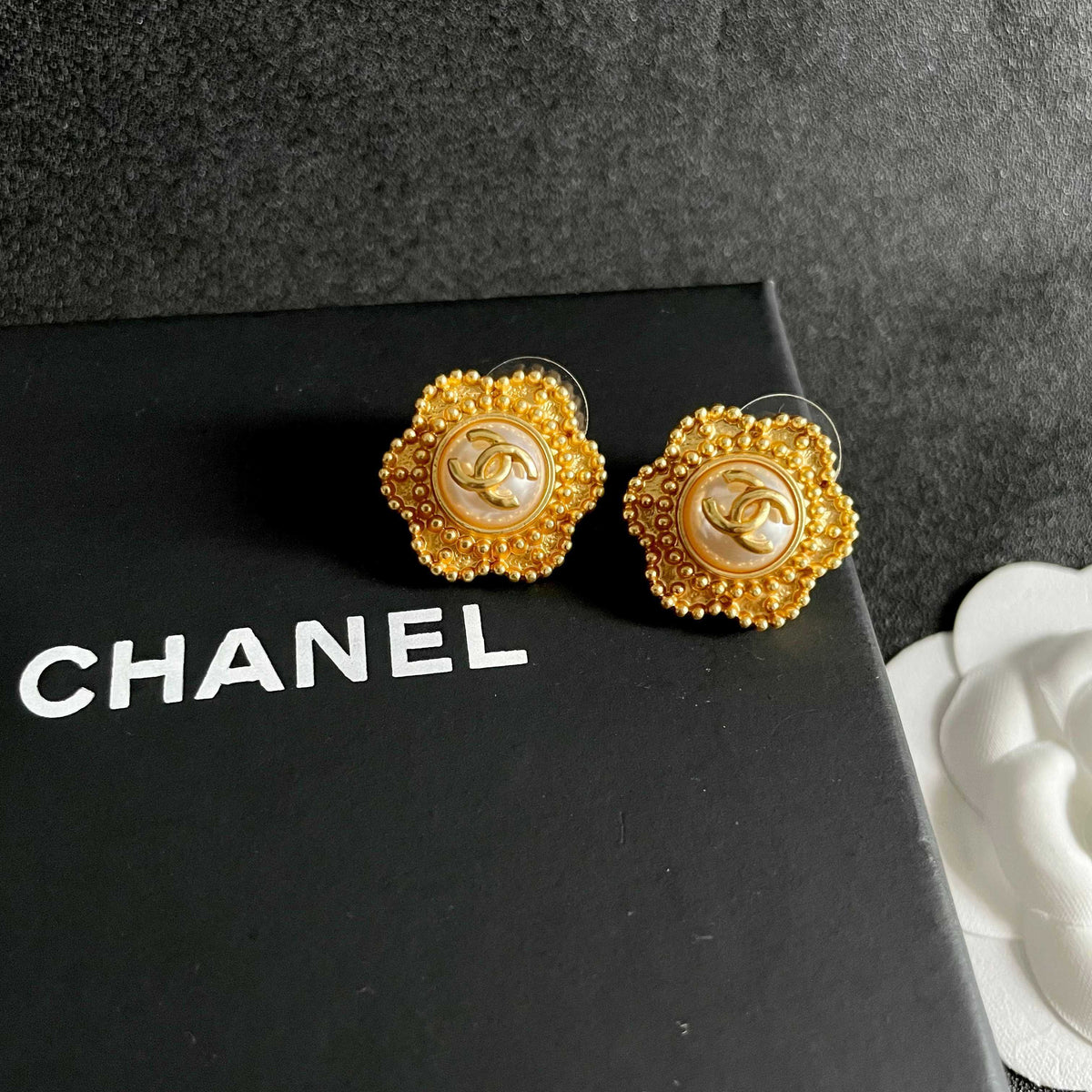 Martin Graham stud earrings in polished metal-tone – detail view