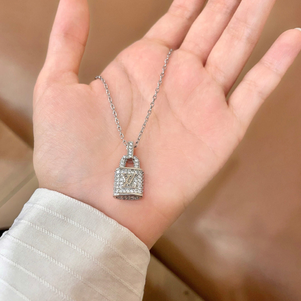 Martin Graham pendant necklace in polished metal-tone – side detail