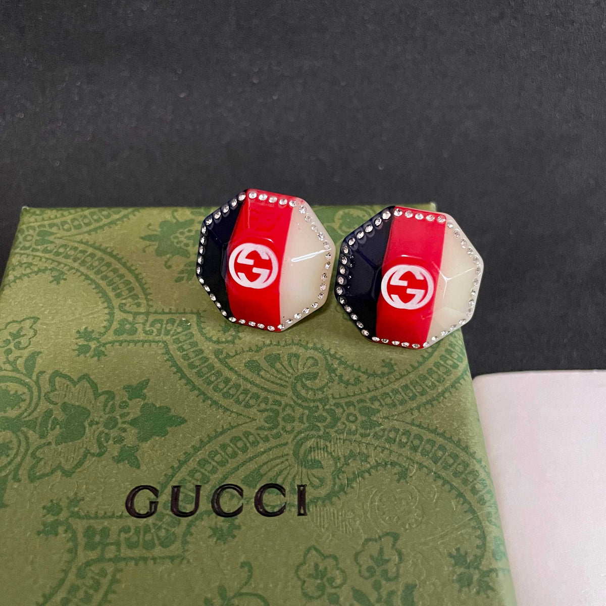 Martin Graham stud earrings in polished metal-tone – detail view