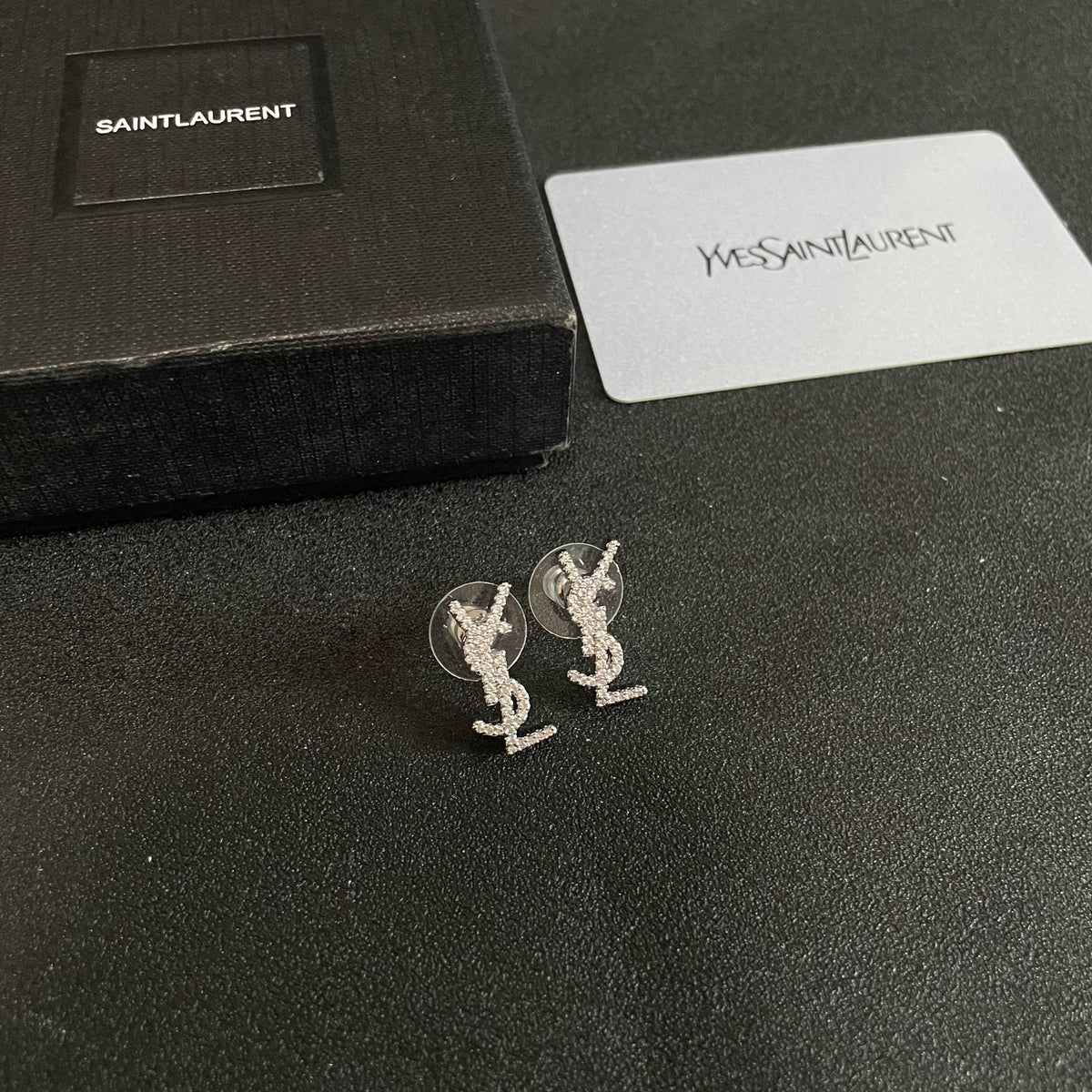Martin Graham stud earrings in polished metal-tone – close-up detail