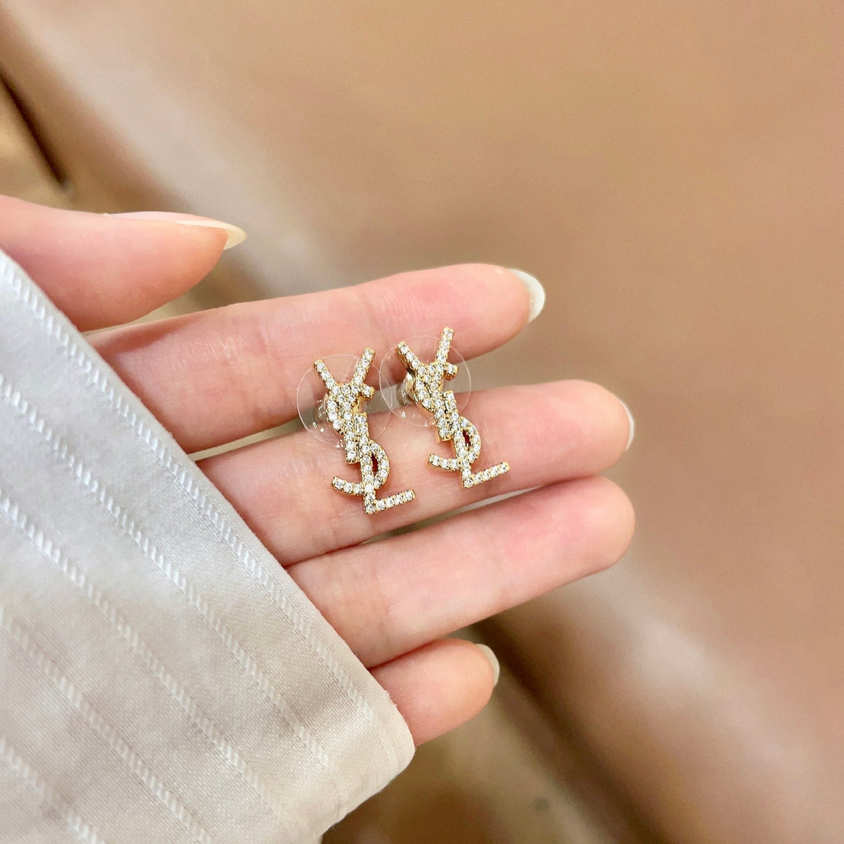 Martin Graham stud earrings in polished metal-tone – side detail