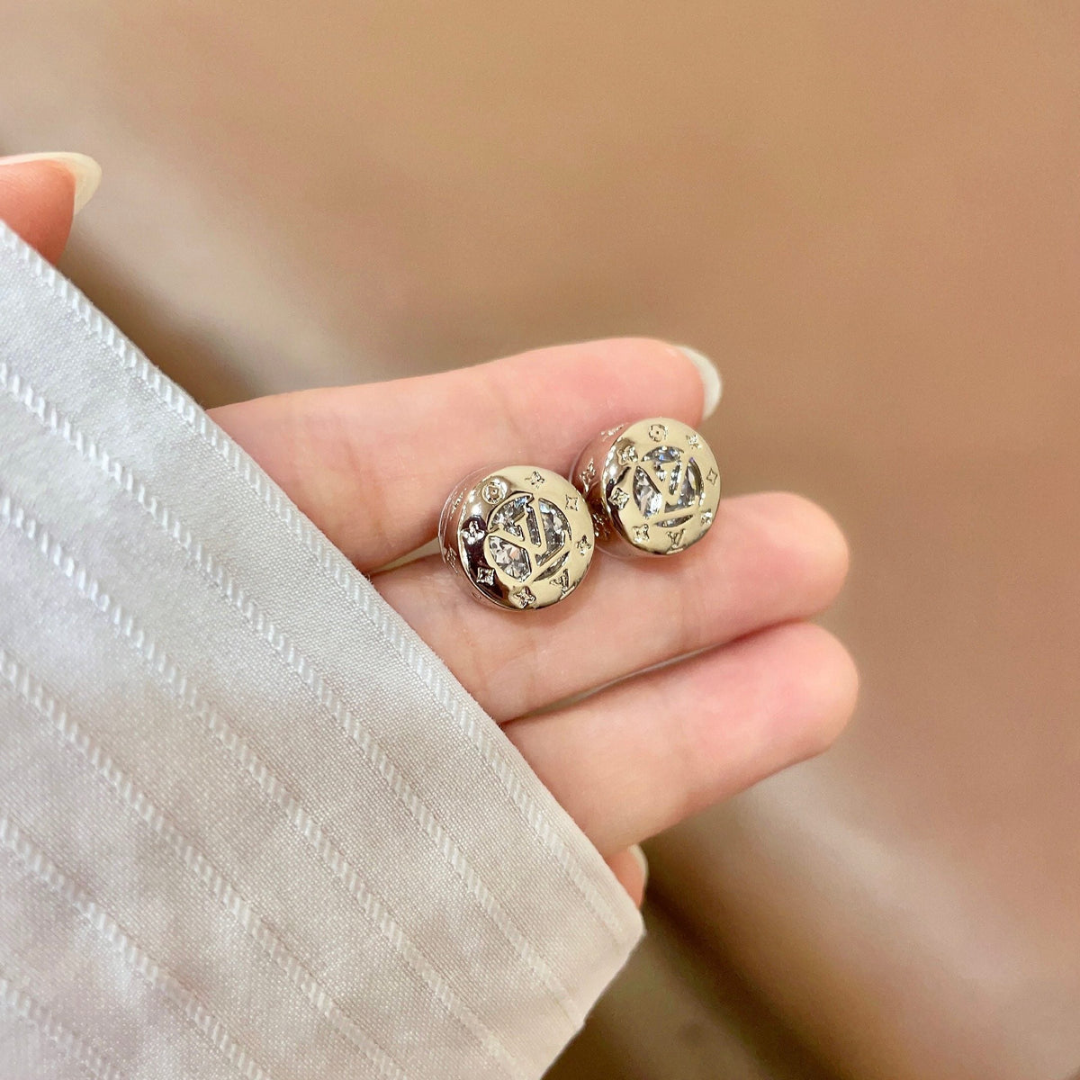 Martin Graham stud earrings in polished metal-tone – side detail