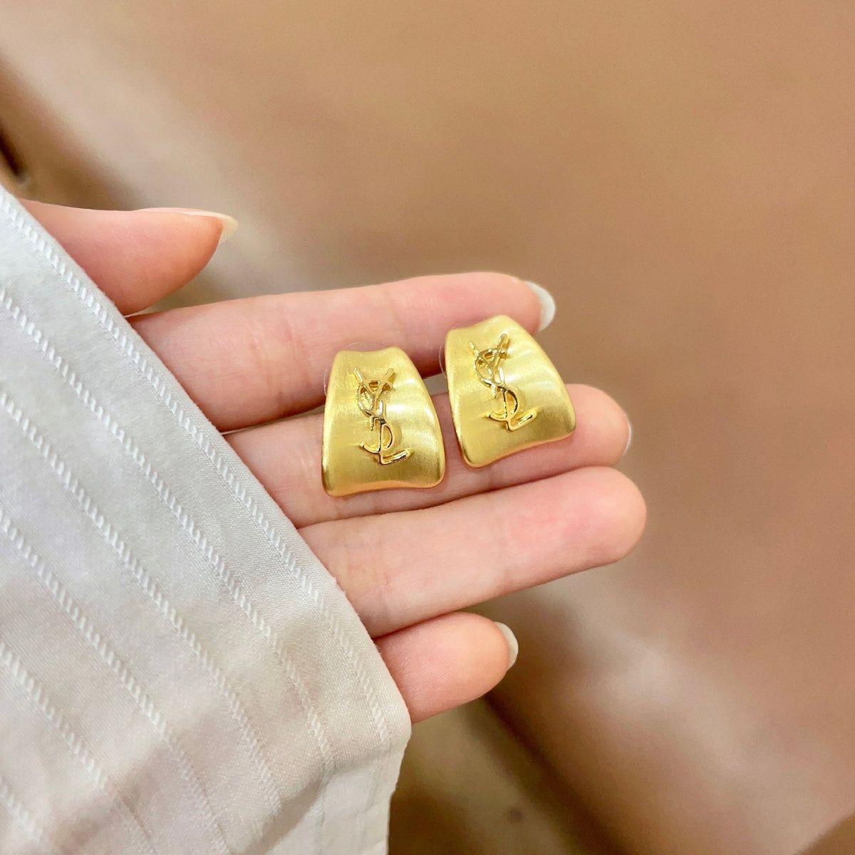 Martin Graham stud earrings in polished metal-tone – side detail