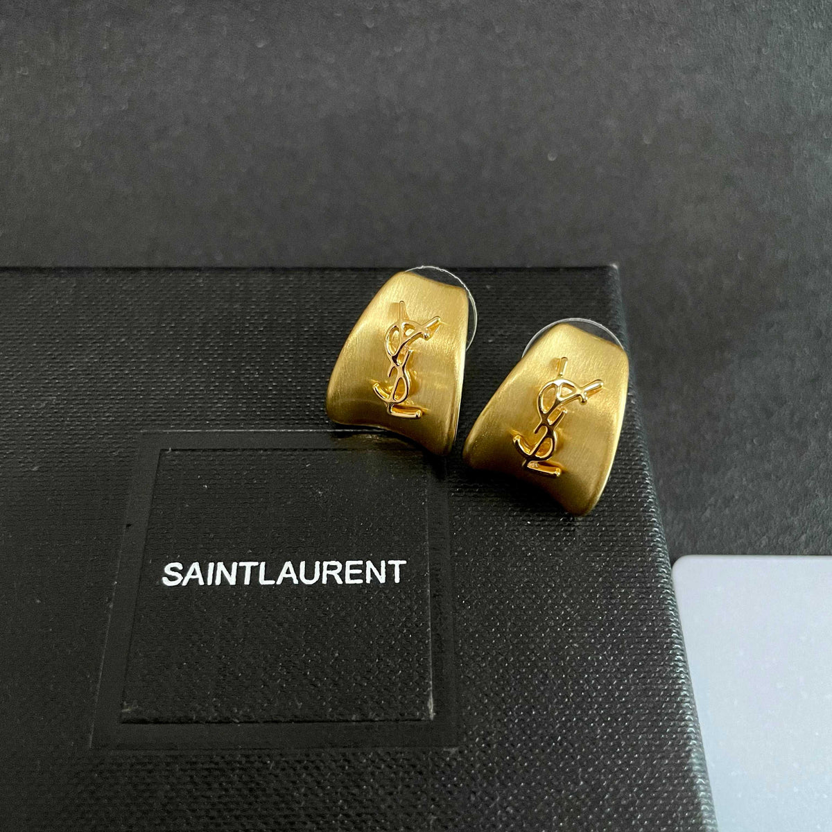 Martin Graham stud earrings in polished metal-tone – detail view