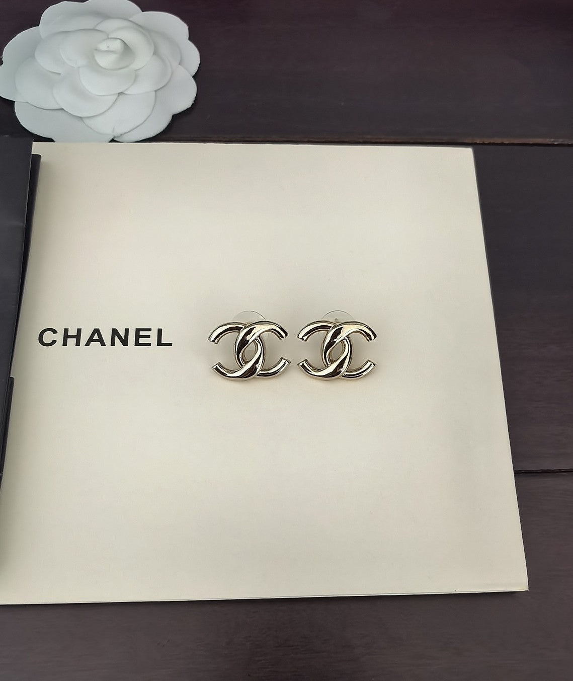Martin Graham stud earrings in polished metal-tone – close-up detail