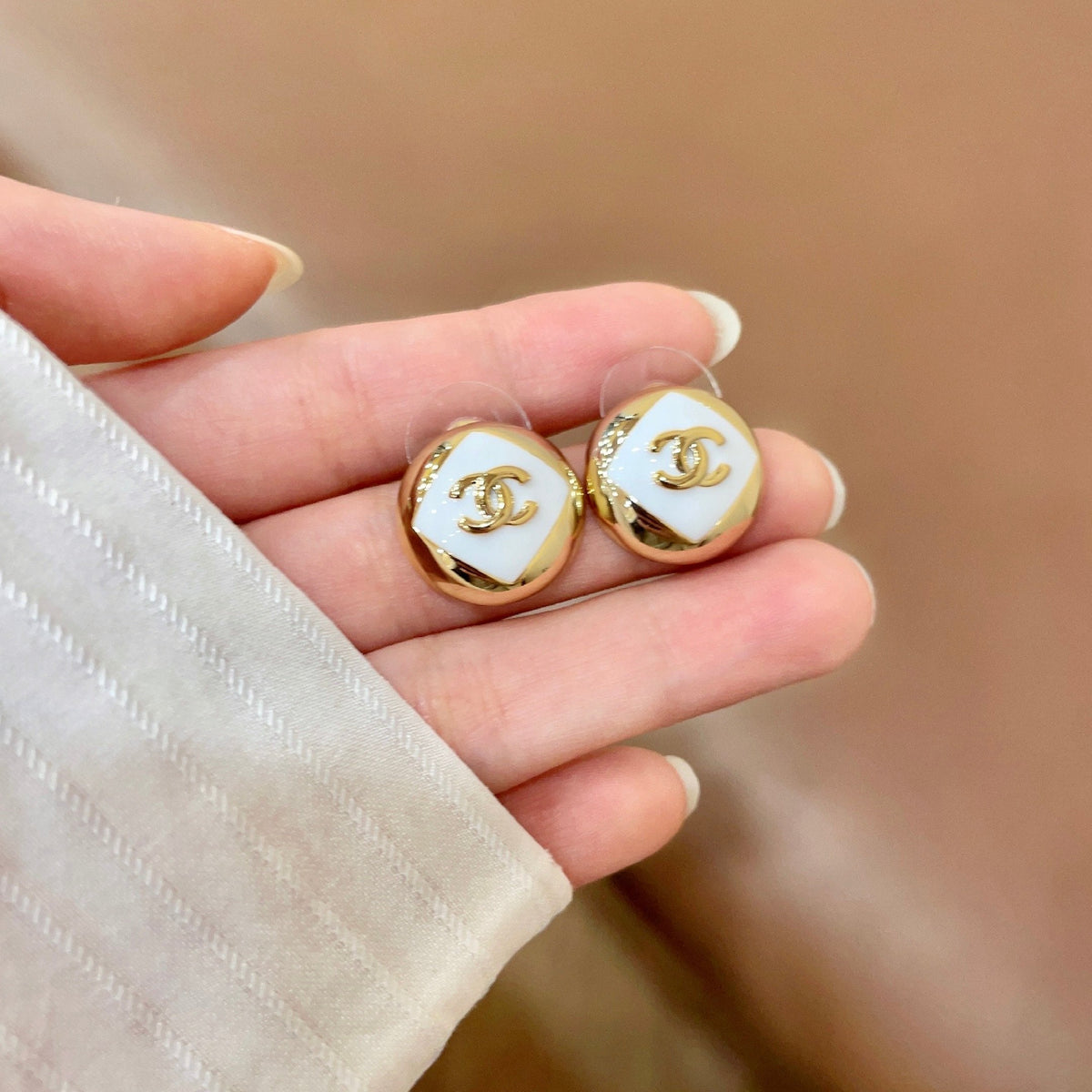 Martin Graham stud earrings in polished metal-tone – side detail