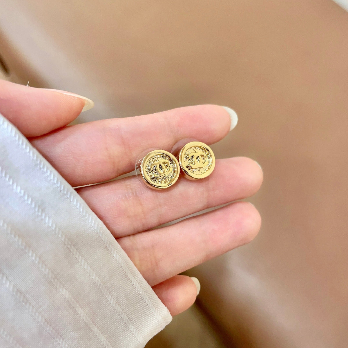 Martin Graham stud earrings in polished metal-tone – side detail
