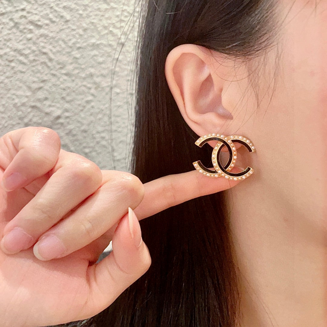 Martin Graham stud earrings in polished metal-tone – front product view