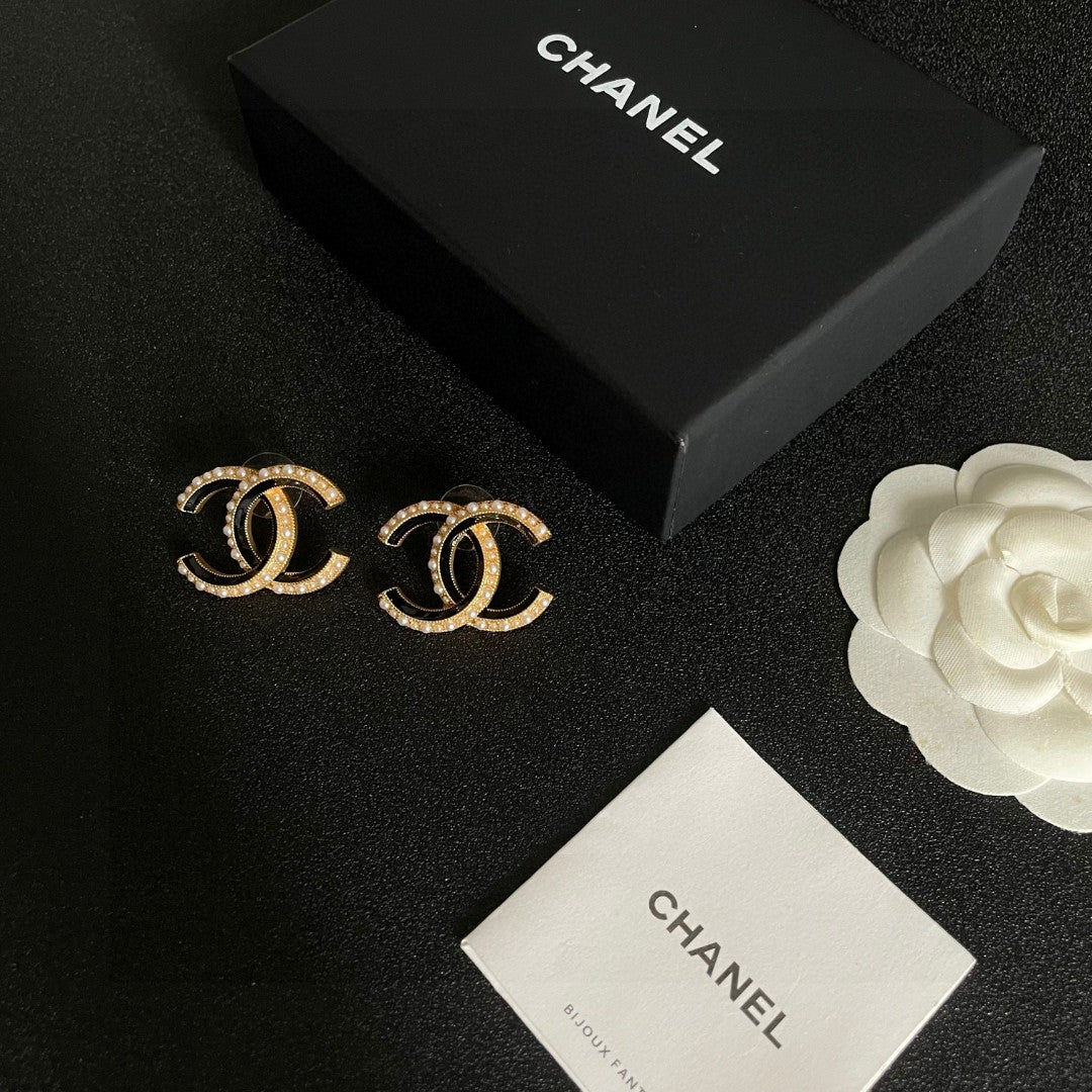 Martin Graham stud earrings in polished metal-tone – close-up detail