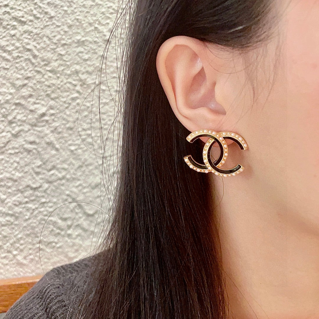 Martin Graham stud earrings in polished metal-tone – detail view