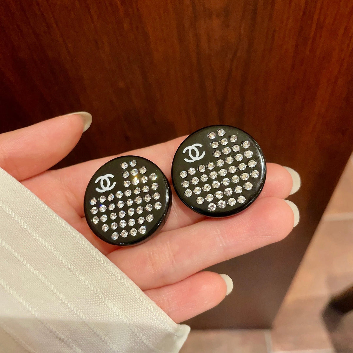 Martin Graham stud earrings in polished metal-tone – side detail