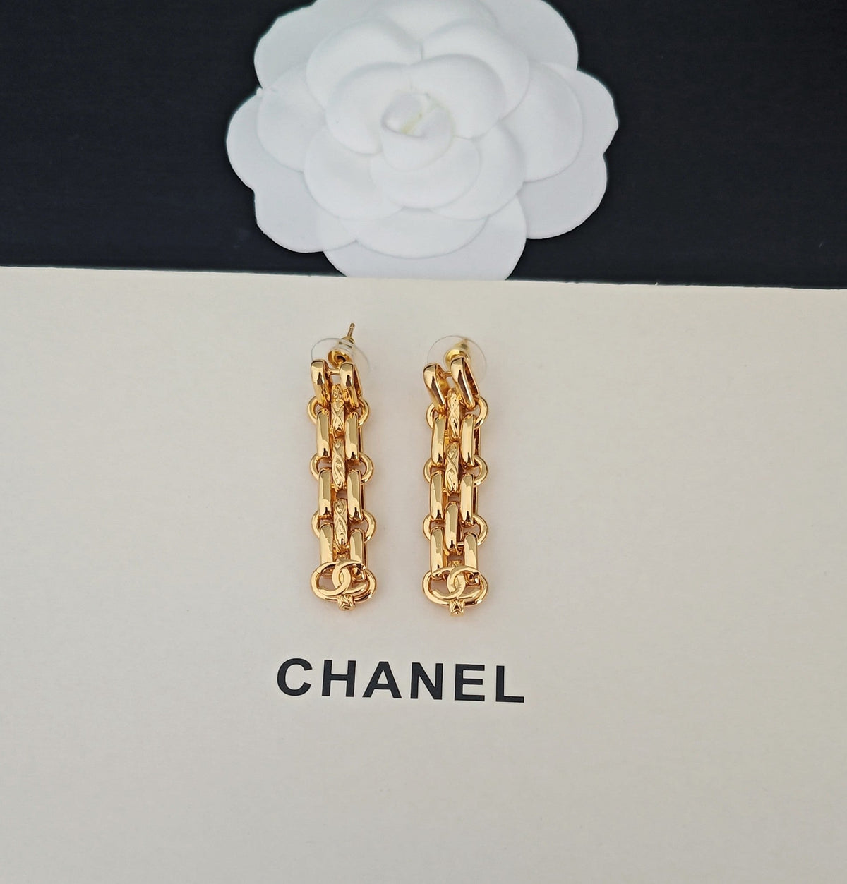 Martin Graham earrings in polished metal-tone – close-up detail