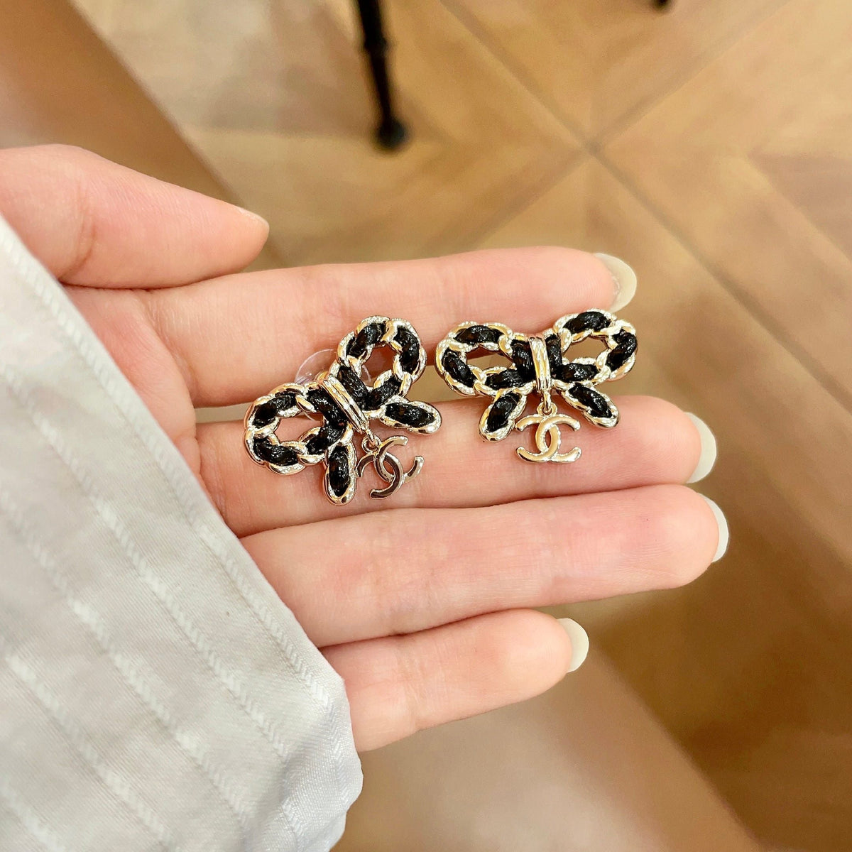 Martin Graham stud earrings in polished metal-tone – side detail