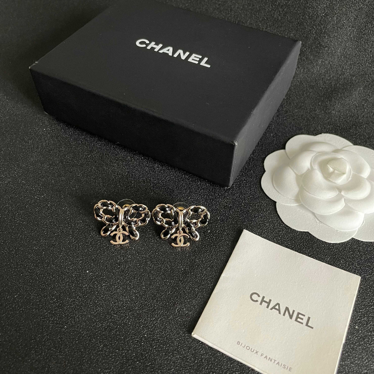Martin Graham stud earrings in polished metal-tone – close-up detail