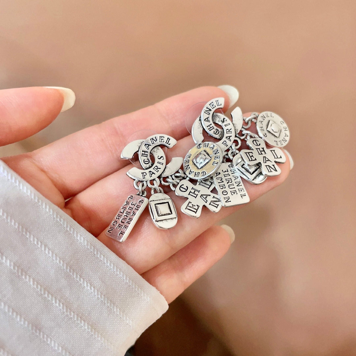 Martin Graham stud earrings in polished metal-tone – side detail