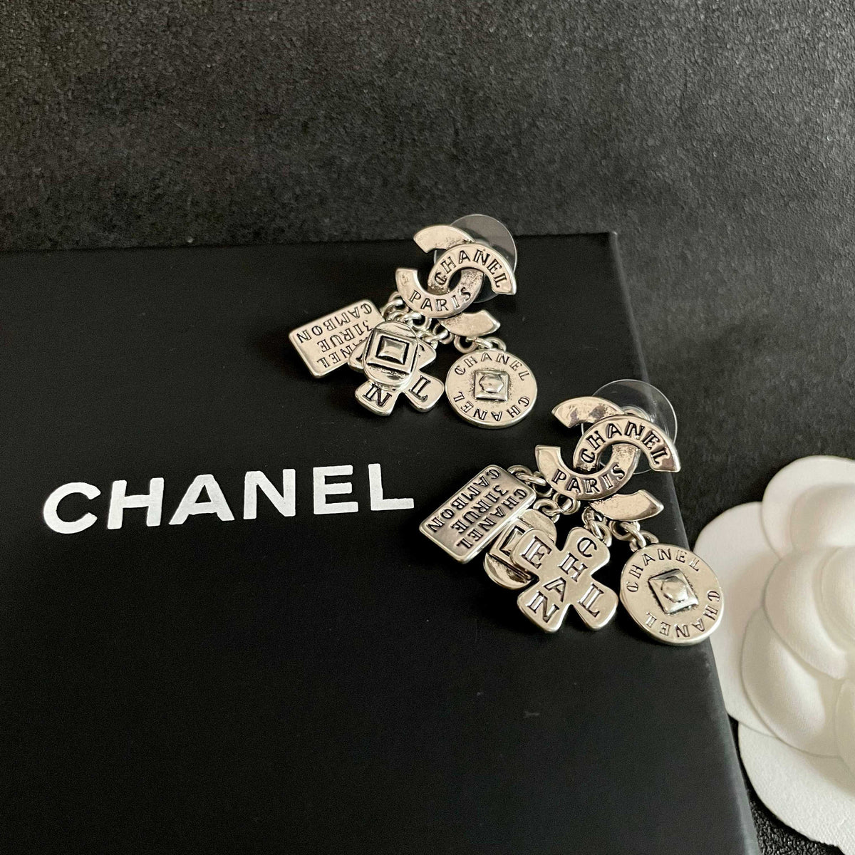 Martin Graham stud earrings in polished metal-tone – detail view