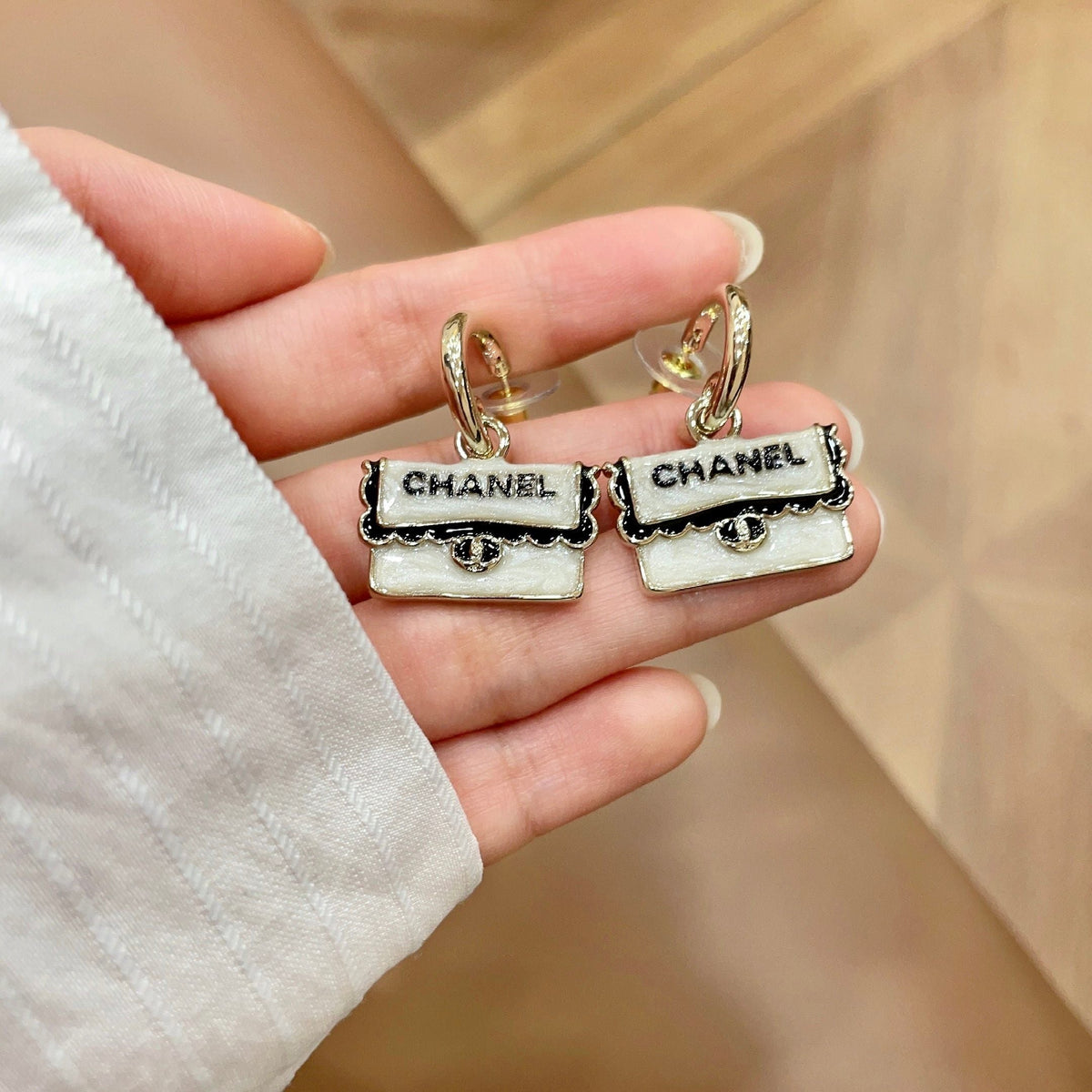 Martin Graham stud earrings in polished metal-tone – side detail