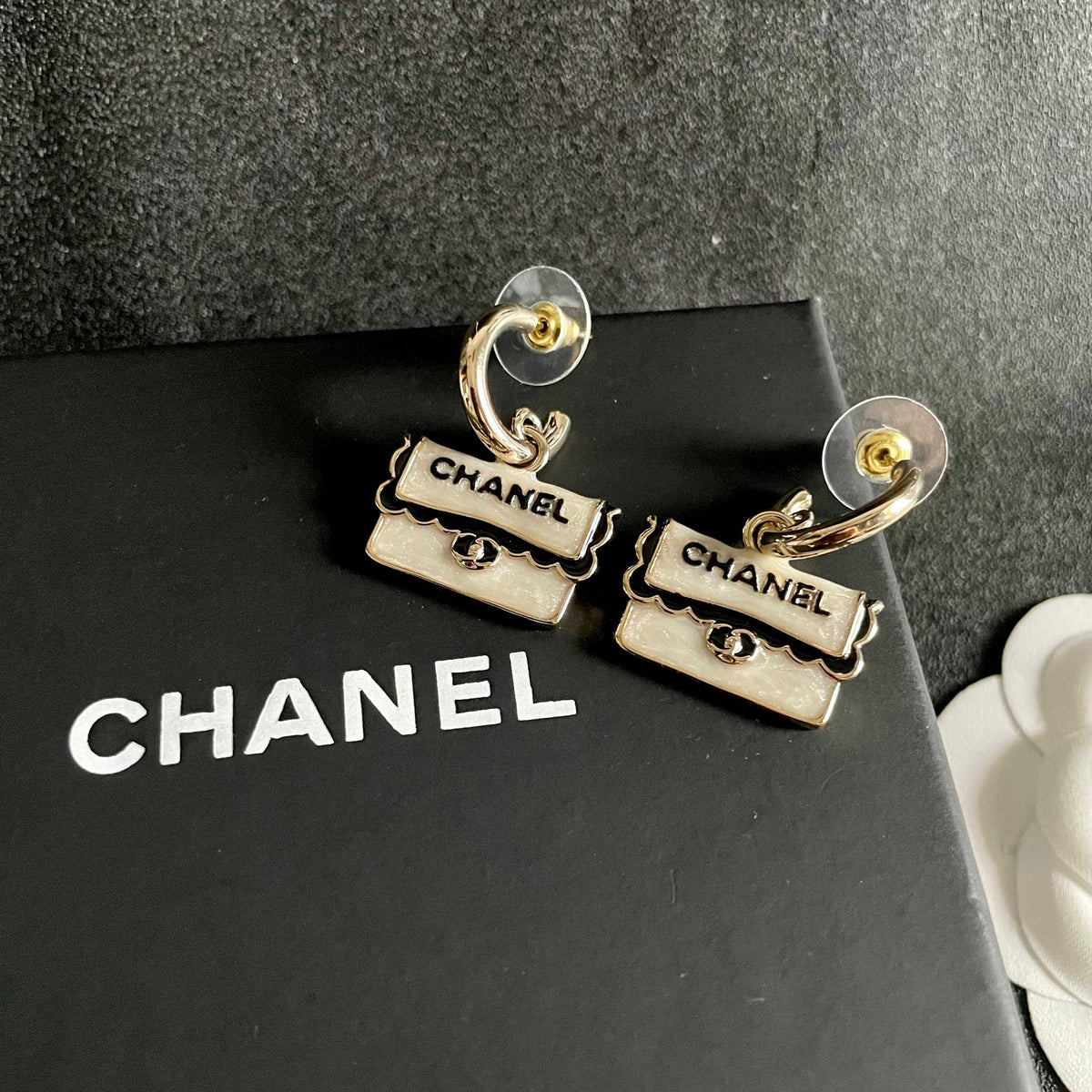Martin Graham stud earrings in polished metal-tone – detail view