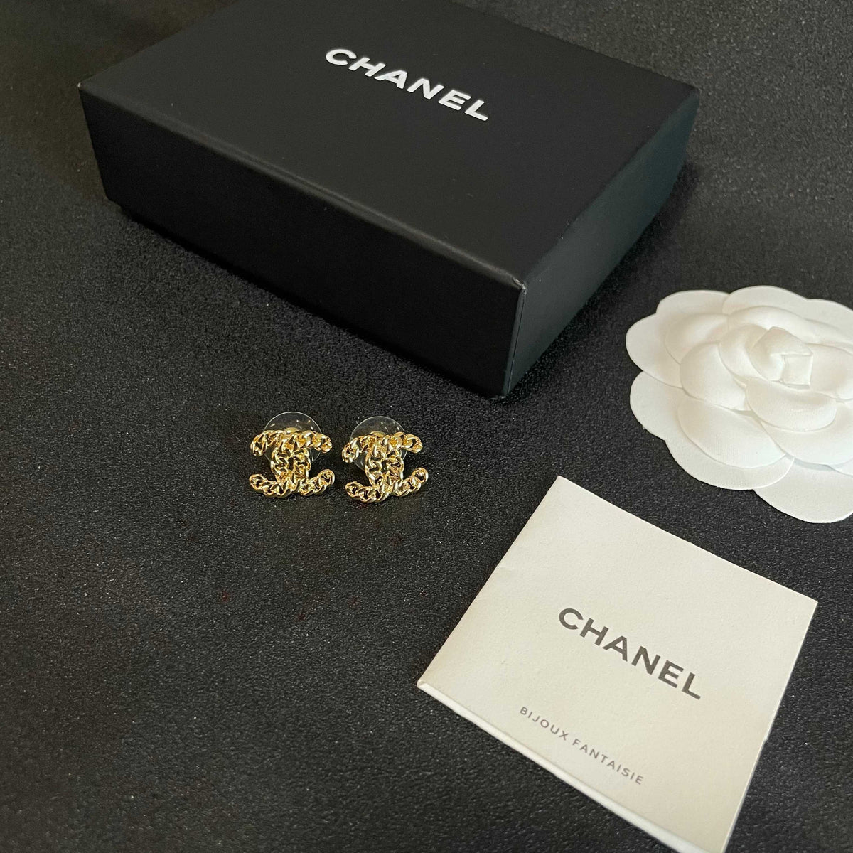 Martin Graham stud earrings in polished metal-tone – close-up detail