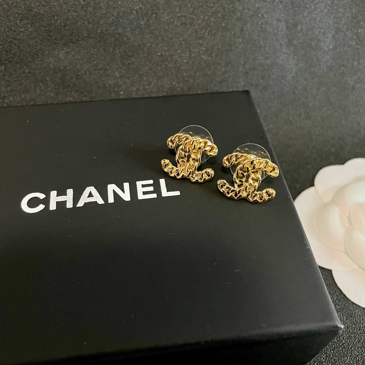 Martin Graham stud earrings in polished metal-tone – detail view