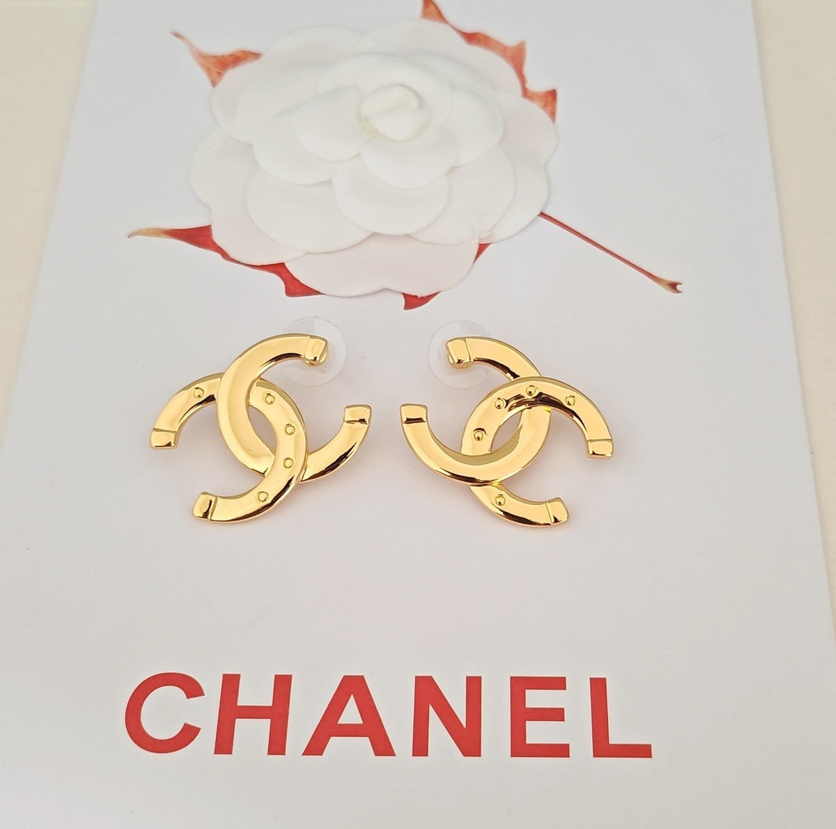 Martin Graham stud earrings in polished metal-tone – close-up detail