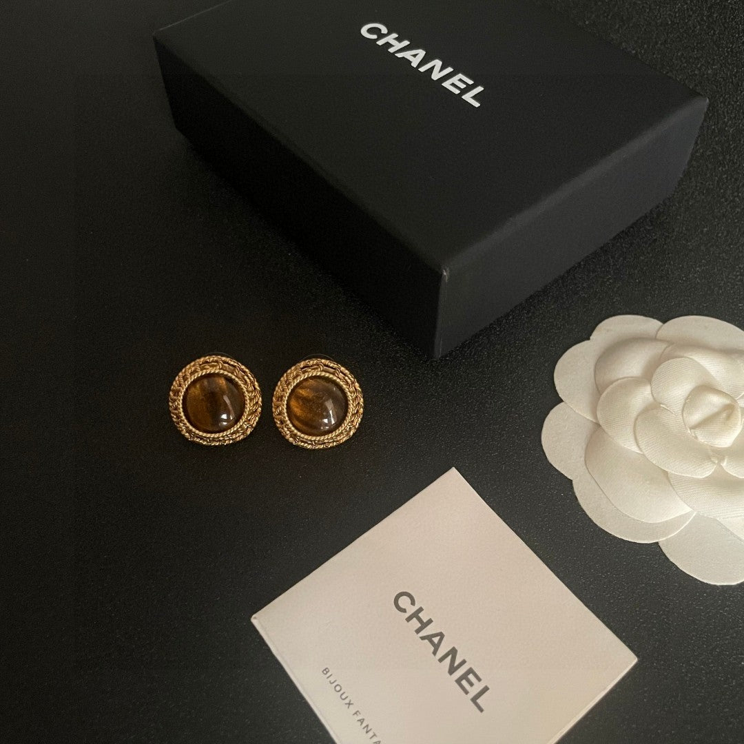 Martin Graham stud earrings in polished metal-tone – close-up detail