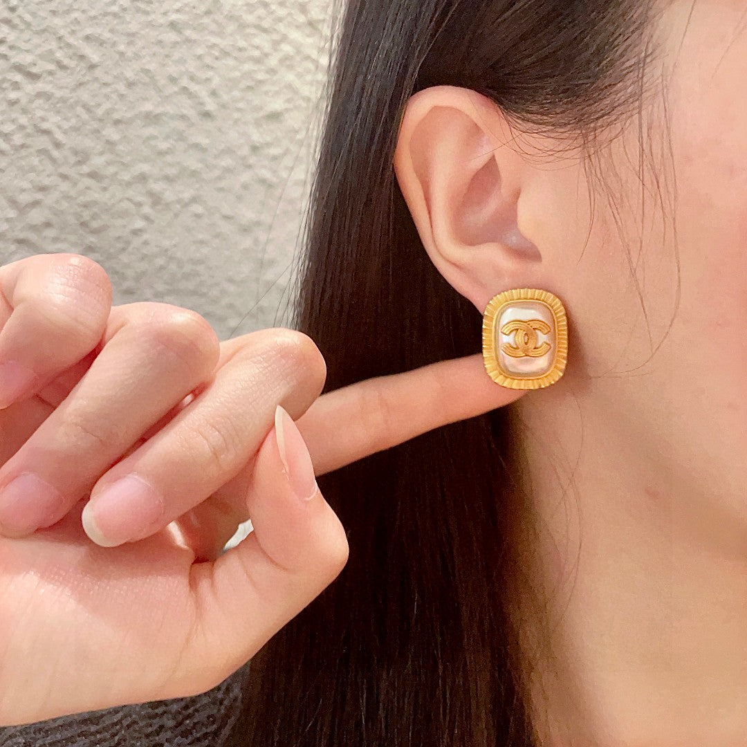 Martin Graham stud earrings in polished metal-tone – front product view