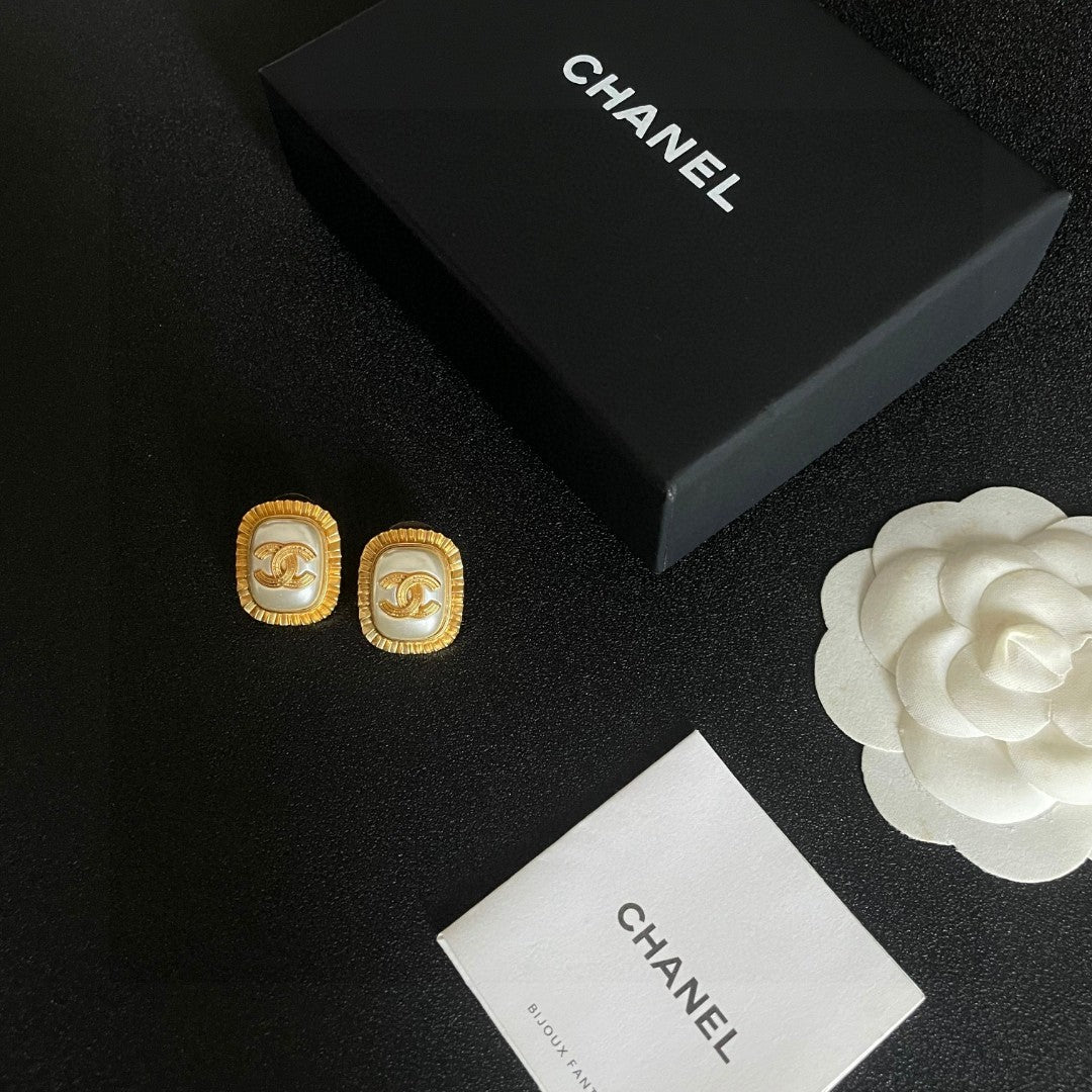 Martin Graham stud earrings in polished metal-tone – close-up detail
