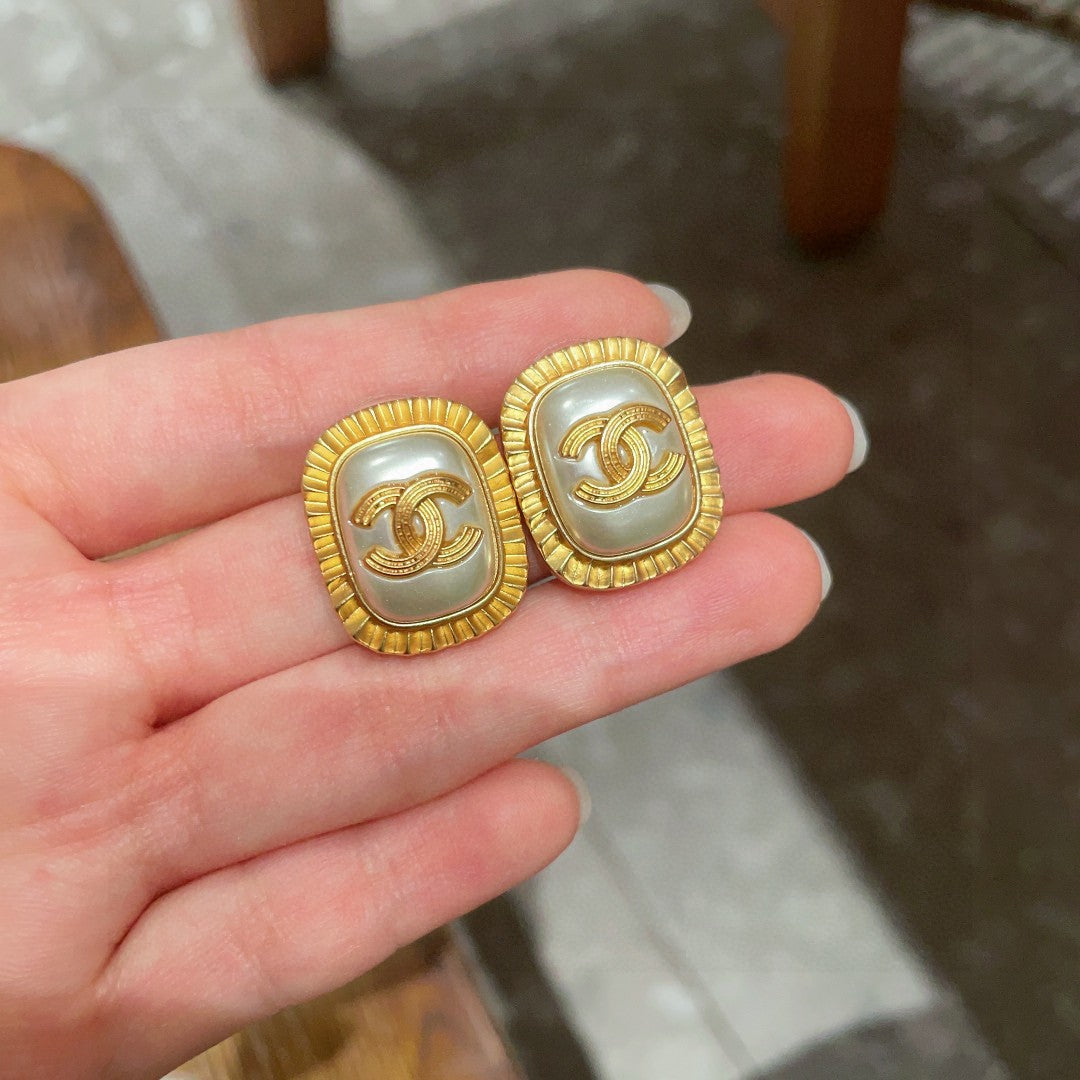 Martin Graham stud earrings in polished metal-tone – side detail