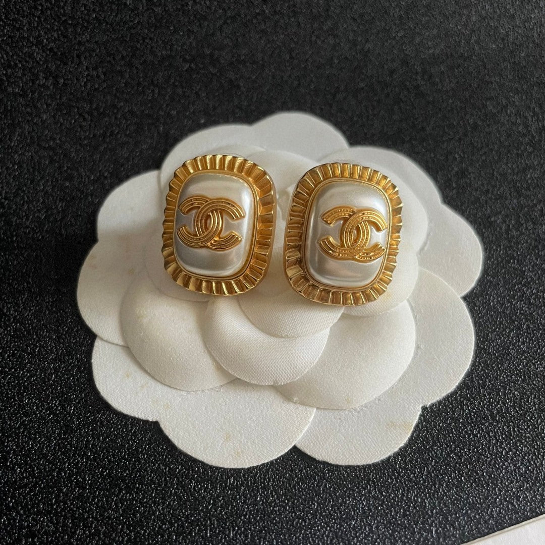 Martin Graham stud earrings in polished metal-tone – front product view